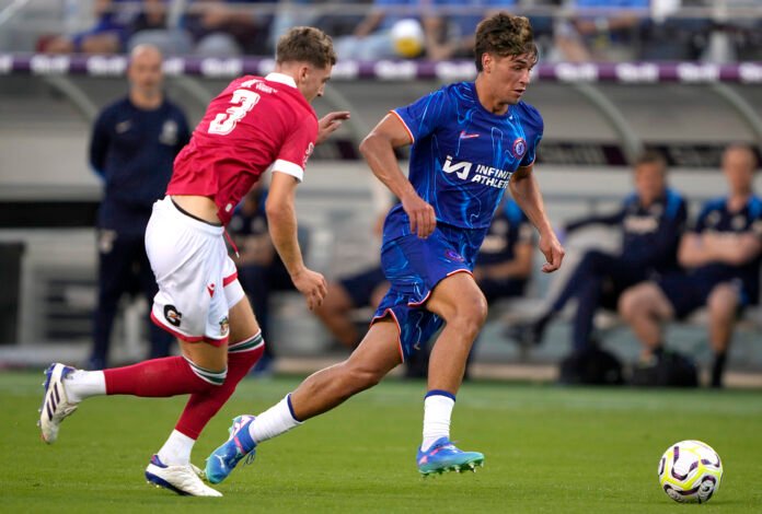 SANTA CLARA, CALIFORNIA - JULY 24: Marc Guiu #38 of Chelsea FC dribbles the ball up field past Lewis Brunt #3 of Wrexham AFC during the first half of a preseason friendly at Levi's Stadium on July 24, 2024 in Santa Clara, California.
