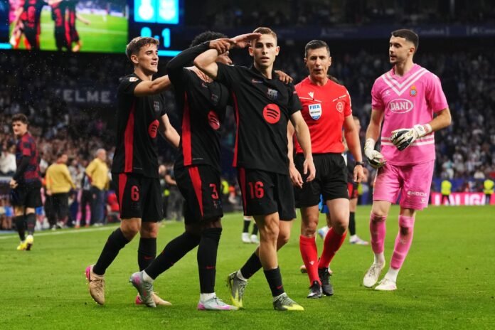 BARCELONA, SPAIN - MAY 15: Fermin Lopez of FC Barcelona celebrates scoring his team's second goal with teammates Gavi and Alejandro Balde during the LaLiga match between RCD Espanyol de Barcelona and FC Barcelona at RCDE Stadium on May 15, 2025 in Barcelona, Spain.