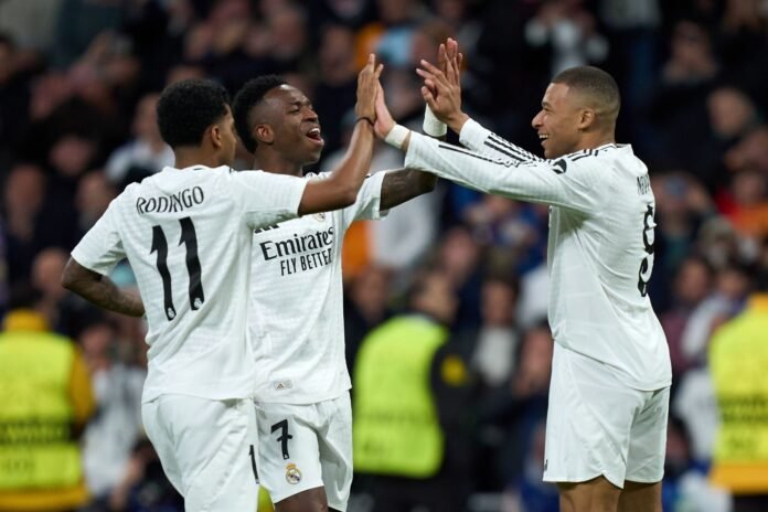 MADRID, SPAIN - JANUARY 22: Kylian Mbappe of Real Madrid celebrates scoring his team's third goal with teammates Rodrygo Goes and Vinicius Junior during the UEFA Champions League 2024/25 League Phase MD7 match between Real Madrid C.F. and FC Salzburg at Estadio Santiago Bernabeu on January 22, 2025 in Madrid, Spain.